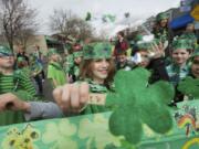 Jones Woods, 7, center, marches in the 2013 Paddy Hough Parade Friday with his second grade class.