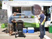 Customers gather at The Mighty Bowl, the first mobile food truck in Vancouver, at the intersection of East 22nd and Main streets at lunch on Wednesday.