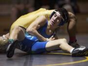 Mountain View's Ben Dixon takes control of Kelso's Abundio Victoriano on his way to winning the district championship at 113 pounds Saturday at Hudson's Bay High School.