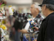 Fred Soto of Vancouver, foreground, eyes a nutcracker at the Goodwill store on Northeast Fourth Plain Boulevard to add to his collection of about 100 nutcrackers.