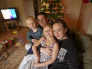 Chandar Pass, 33, and Katie Padgett, 34, get ready for Christmas with their children, Daelan Pass, 2, and Kendra Pass, 5.