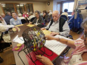 Volunteer Anita Krivitzky calls bingo for residents and visitors at The Quarry Senior Living, a 223-unit assisted- and independent-living community in east Vancouver that is undergoing an expansion.