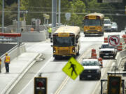 School buses and other traffic travel over the SR 500/St. Johns Blvd interchange Monday in Vancouver as the road construction project nears completion.