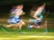 Panning is a classic technique that allows a photographer to create a sense of motion, as in this photo taken during a cross-country meet with Skyview,  Heritage and Evergreen high schools.