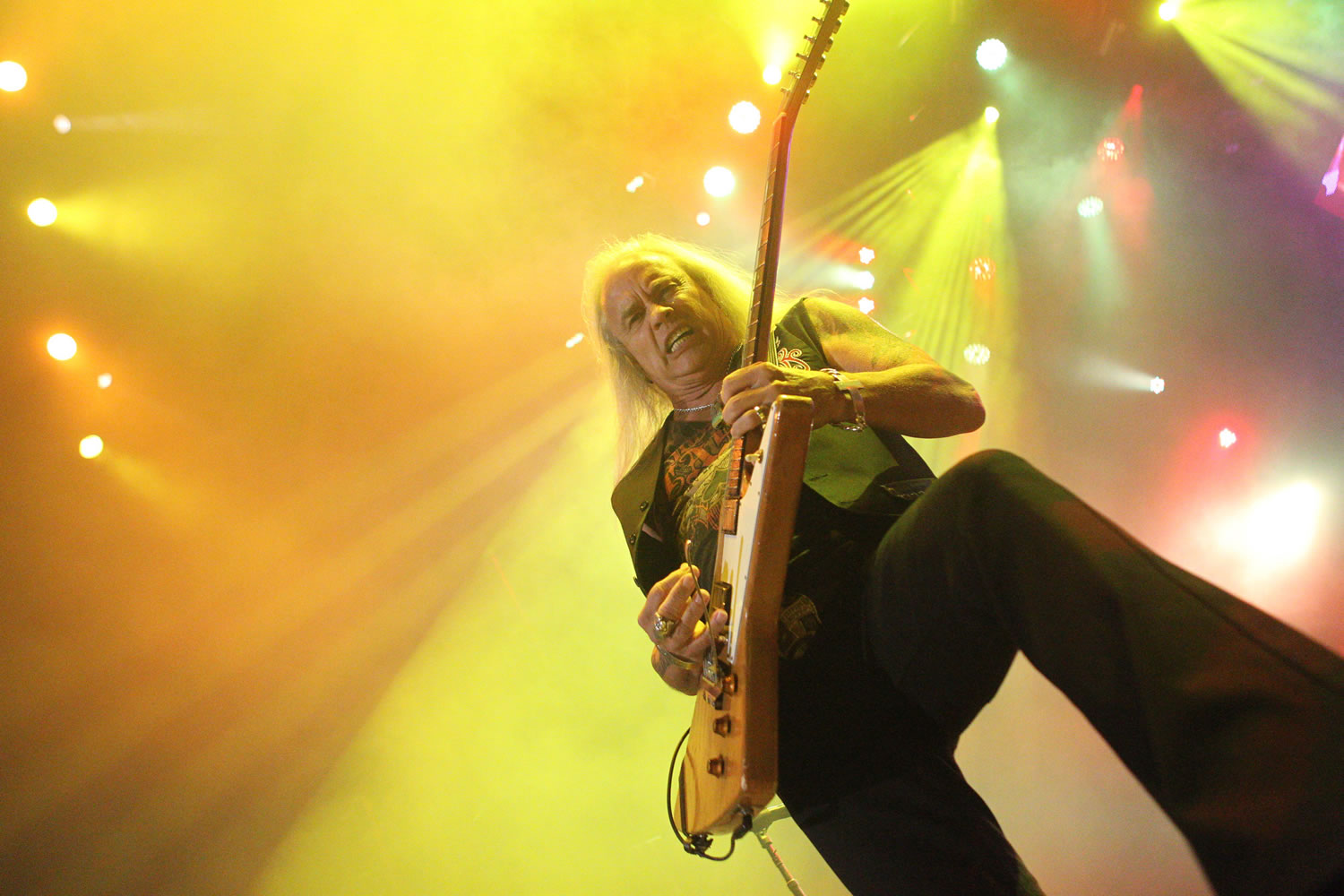 Columbian photo intern Brianna Loper aimed upward to use the stage lights as a colorful backdrop for her picture of Lynyrd Skynyrd guitarist Rickey Medlocke during the group's concert with Bad Company on June 21 at the Sleep Country Amphitheater in Ridgefield.