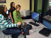 Ridgefield: View Ridge Middle School eighth graders Taryn Ries, from left, Makayla Draper and Rosaline Mayfield use a flight simulator purchased with $500 in grant funding from the Ridgefield Public Schools Foundation.