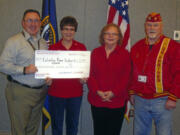 Central Park: Shaun Benson, from left, chief of voluntary service at the Portland Veterans Affairs Medical Center, accepts a Fisher House donation of $1,100 from Ellen Rueckert and Karen Baste' of the Columbia River Marine Corps League Auxiliary No. 398 and Rex Hopper of the Columbia River Marine Corps League Detachment No.