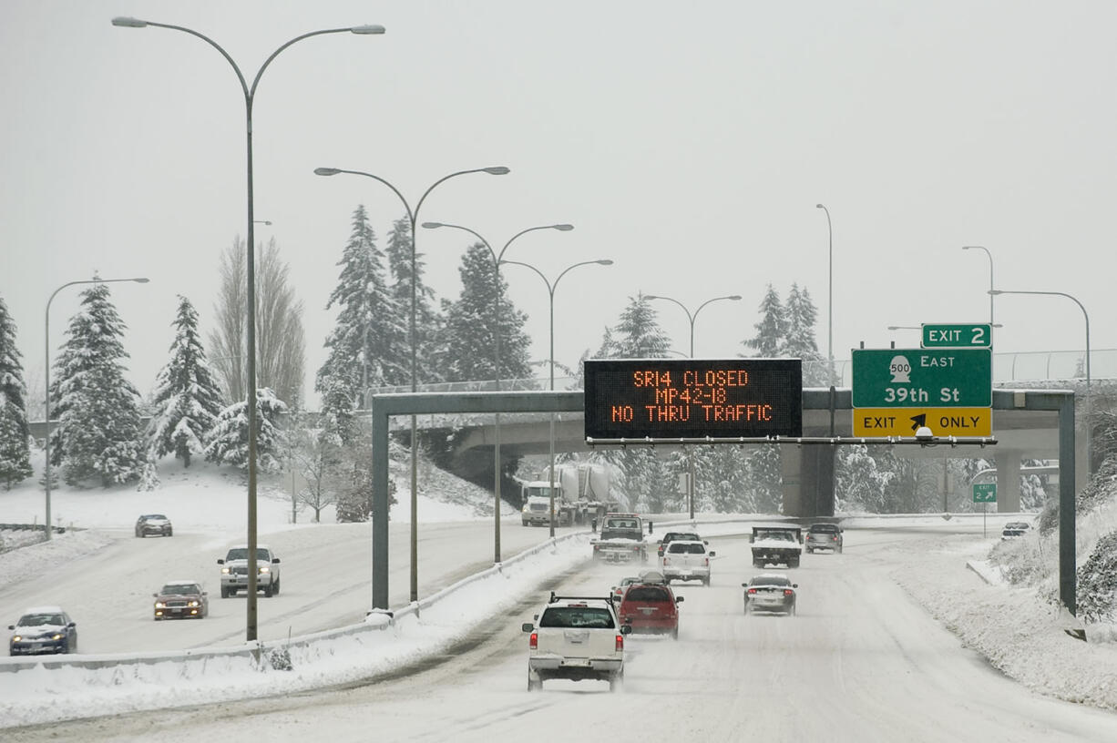 A sign on southbound Interstate 5 warns Monday-morning commuters of a road closure on state Highway 14 on Dec.