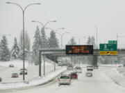 A sign on southbound Interstate 5 warns Monday-morning commuters of a road closure on state Highway 14 on Dec.