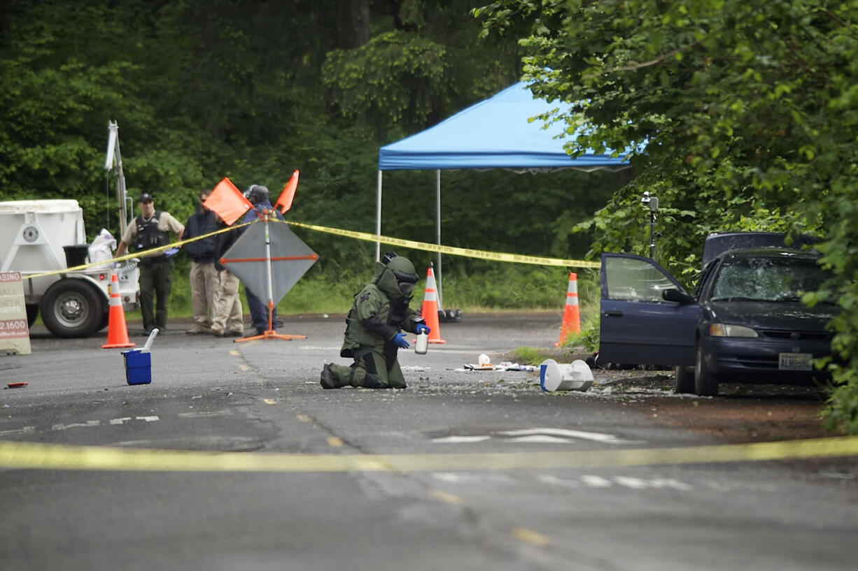 Vancouver police investigate the scene of an auto explosion and fire Tuesday at 9101 N.E.