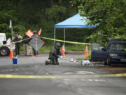 Vancouver police investigate the scene of an auto explosion and fire Tuesday at 9101 N.E.