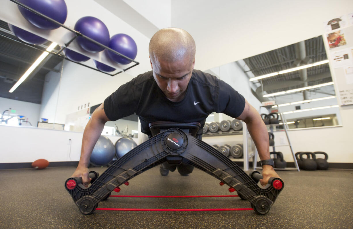 Nautilus employee Dave Patania demonstrates the Bowflex Upper Cut on Monday.