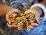 Vancouver resident and cookbook author Chrisetta Mosley scoops up a handful of homemade fruit and nut granola.