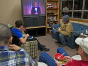 Men watch the Golden Globe awards Sunday on a donated television at St. Paul Lutheran Church.