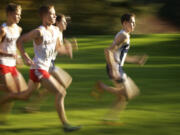 Kaden Harbertson, right, of Skyview High School competes in the Class 4A district cross country meet Wednesday at Lewisville Park near Battle Ground.