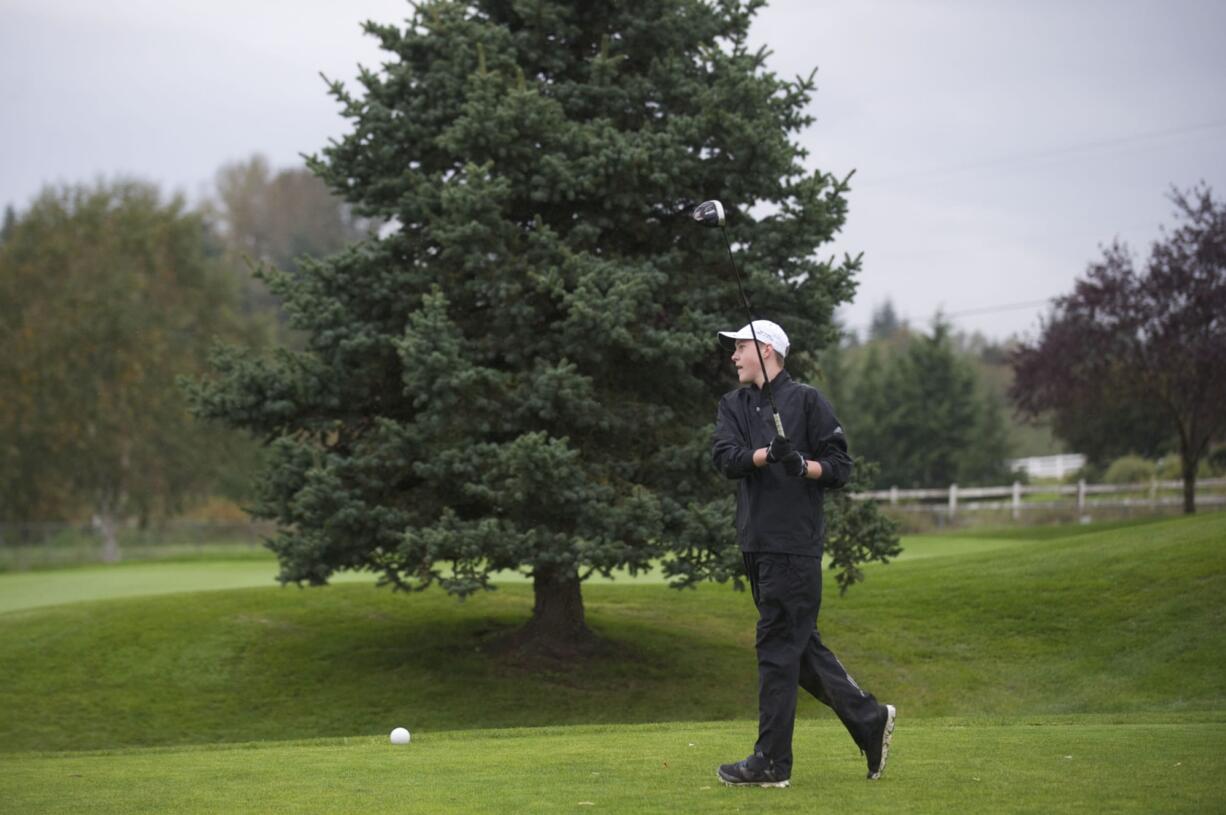 Fort Vancouver's Spencer Tibbits tee's off on the first hole as he closes in on the 3A district golf title at Tri-Mountain Golf Course on Tuesday.