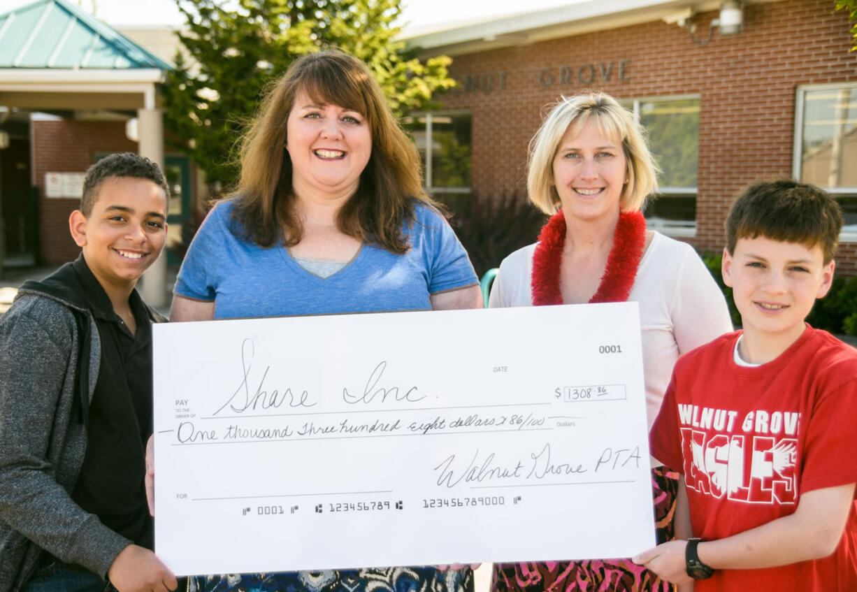 Walnut Grove: Fifth-grade students Logan Moody, left, and Zane Walter, far right, along with Walnut Grove Elementary Principal Bobbi Geenty, present a check to Share representative Sue Warren, second from right.