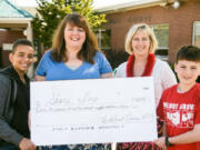 Walnut Grove: Fifth-grade students Logan Moody, left, and Zane Walter, far right, along with Walnut Grove Elementary Principal Bobbi Geenty, present a check to Share representative Sue Warren, second from right.