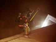 A firefighter battles a duplex fire at 1909 Columbia St.