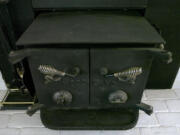 An old wood stove insert sits inside the Ogden neighborhood home of Nancy McNatt in 2008.