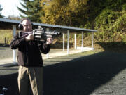 Clark County Sheriff's detective Todd Barsness demonstrates firing a 'less-lethal' weapon at the sheriff's firing range earlier this year.