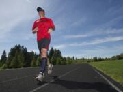 Camas resident Darren Smith runs a workout on the track at Skyridge Middle School on Wednesday. Smith, 47, is a paratriathlete.