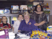 Hazel Dell: Oregon FL Club President Jody Morris (seated) is thanked by Hazel Dell Elementary School learning support teacher Marti Lloid and two of her students for donating a tableful of school supplies last month.