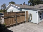 Boards are missing from a gate where an intruder entered the backyard at 3719 N.E. 54th Ave.