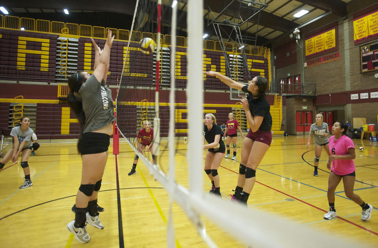 Prairie volleyball co-captain Kaylee Warren hits the ball with fellow captain Malea Doerfler behind her during practice.