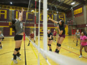 Prairie volleyball co-captain Kaylee Warren hits the ball with fellow captain Malea Doerfler behind her during practice.