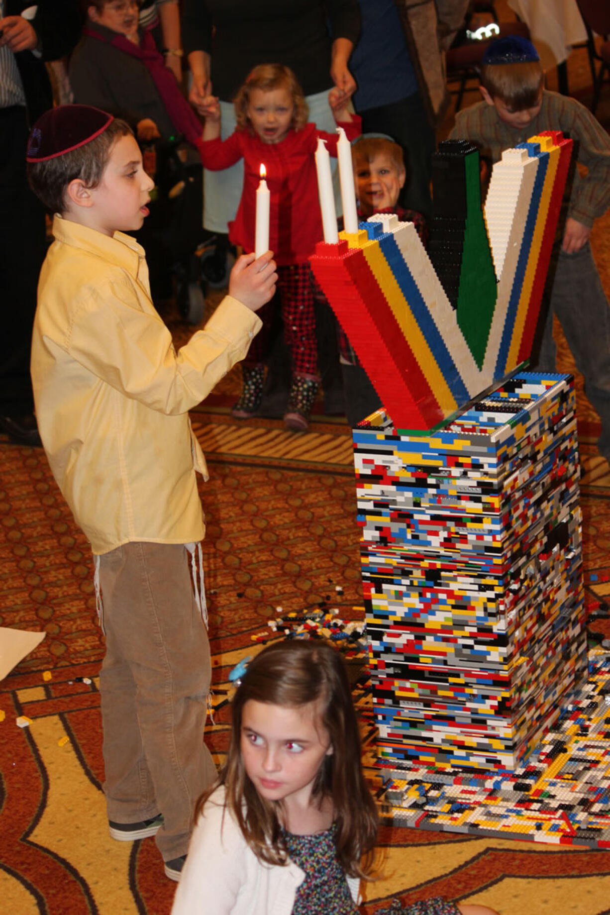 Esther Short: Mendel Greenberg places candles on a Lego menorah on Dec. 9 at the Hilton Vancouver Washington.