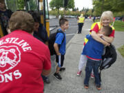 Jane Olschewsky gives returning 5th grader Josh Krzysiak, 10, a big hug as he gets off the bus on the first day of school at the temporary Crestline Elementary today.