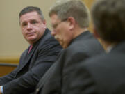 Skamania County's former auditor, John Michael Garvison, left, listens to attorneys during legal proceedings Thursday in Judge Barbara Johnson's courtroom after pleading guilty to shredding public documents.