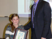 Ridgefield: South Ridge Elementary School second-grader Emma Waddle and Ridgefield School District Superintendent Nathan McCann celebrating Emma&#039;s win the district&#039;s annual Holiday Greeting Card Contest.