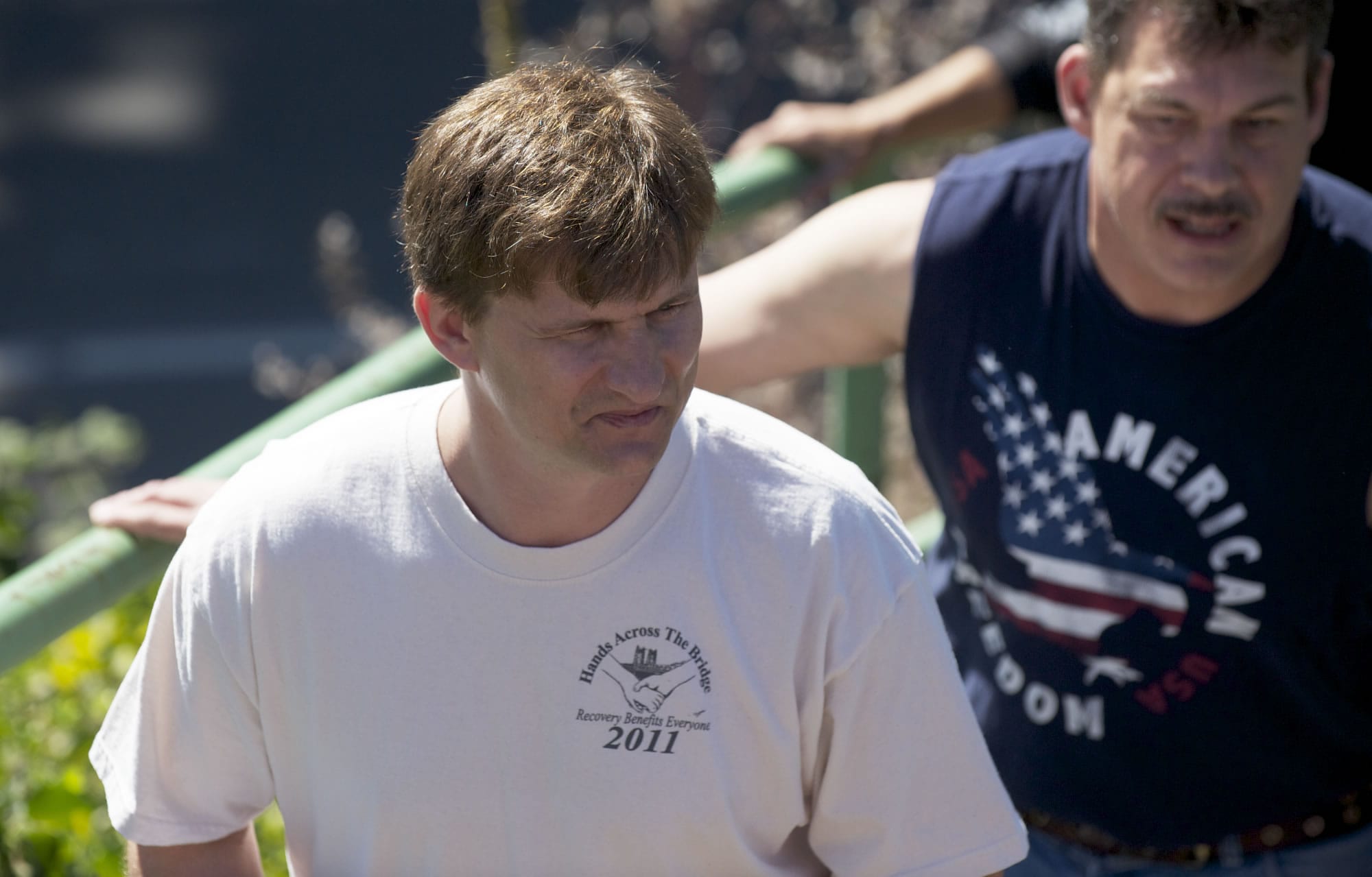 Thomas Breitenbauch, left, an event organizer, makes his way to the I-5 Bridge during the celebration.