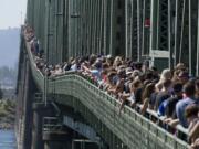 Thousands line the I-5 Bridge during the 8th annual Hands Across the Bridge celebration, Monday.