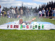 Ridgefield: A Ridgefield High School student celebrates the end of the school year by sliding into a row of plastic pop bottles during the &quot;Human Bowling&quot; event of the school's annual Spudder Olympics celebration May 31.