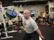 Camas offensive lineman Drew Clarkson trains in the weight room. Clarkson reportedly will play football at Oregon State.