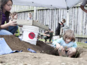 Photos by Vivian Johnson for The Columbian
Maddie Heckert, 7, digs as Teyline McLean sifts dirt in a mock archaeology exercise at Fort Vancouver.