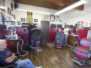 Barber &quot;Big Rick&quot; Conn, left, and owner Rochelle Debuse tend to customers Wednesday at Bernie &amp; Rollies Barber Shop, which will close after Saturday's 8 a.m. to 3 p.m. shift and reopen Tuesday at 10304 Southeast Mill Plain Boulevard.