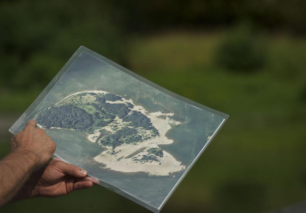 Columbia Land Trust stewardship lead Dan Friesz holds a map of Pierce Island during a walk through the island this week.