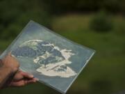 Columbia Land Trust stewardship lead Dan Friesz holds a map of Pierce Island during a walk through the island this week.