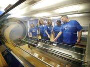 Joyce Garcia, from left, Tricia Walsh, Amy Lara, Robin Jones and Billy Kealiher -- all staff members with PeaceHealth Southwest Medical Center Specialty Clinics -- take a closer look at a new hyperbaric oxygen chamber delivered Tuesday morning.