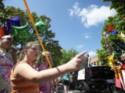 From left, Doug Berg, Emily Berg, 11, and Arianna Stoginais, 10, watch the action go by Saturday during the Camas Days Parade.