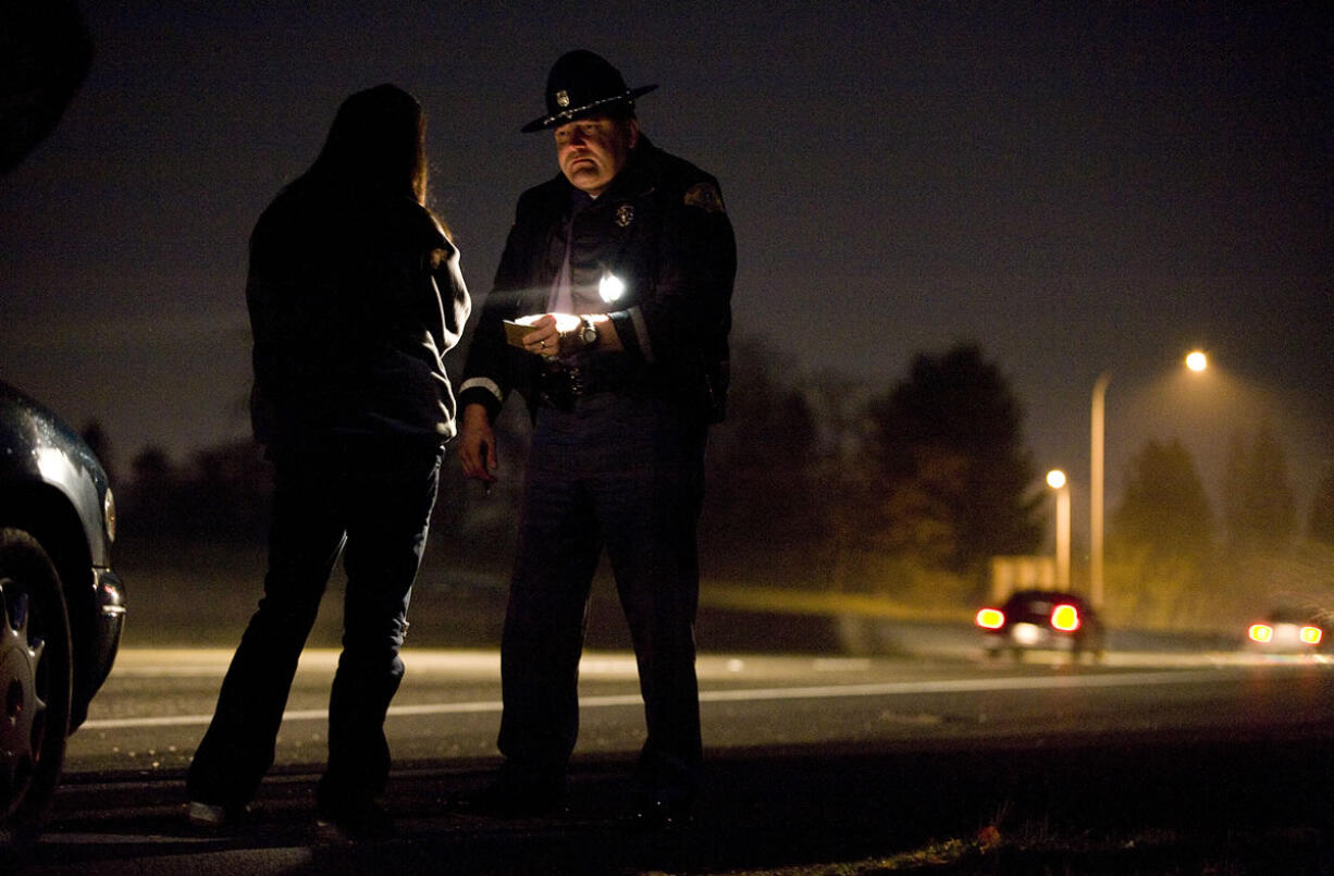 State patrol Trooper Ben Taylor administers a field sobriety test to a driver who nearly crashed her car into a concrete barrier on state Highway 500. Ninety intoxicated drivers were arrested between Aug. 17 and Sept.