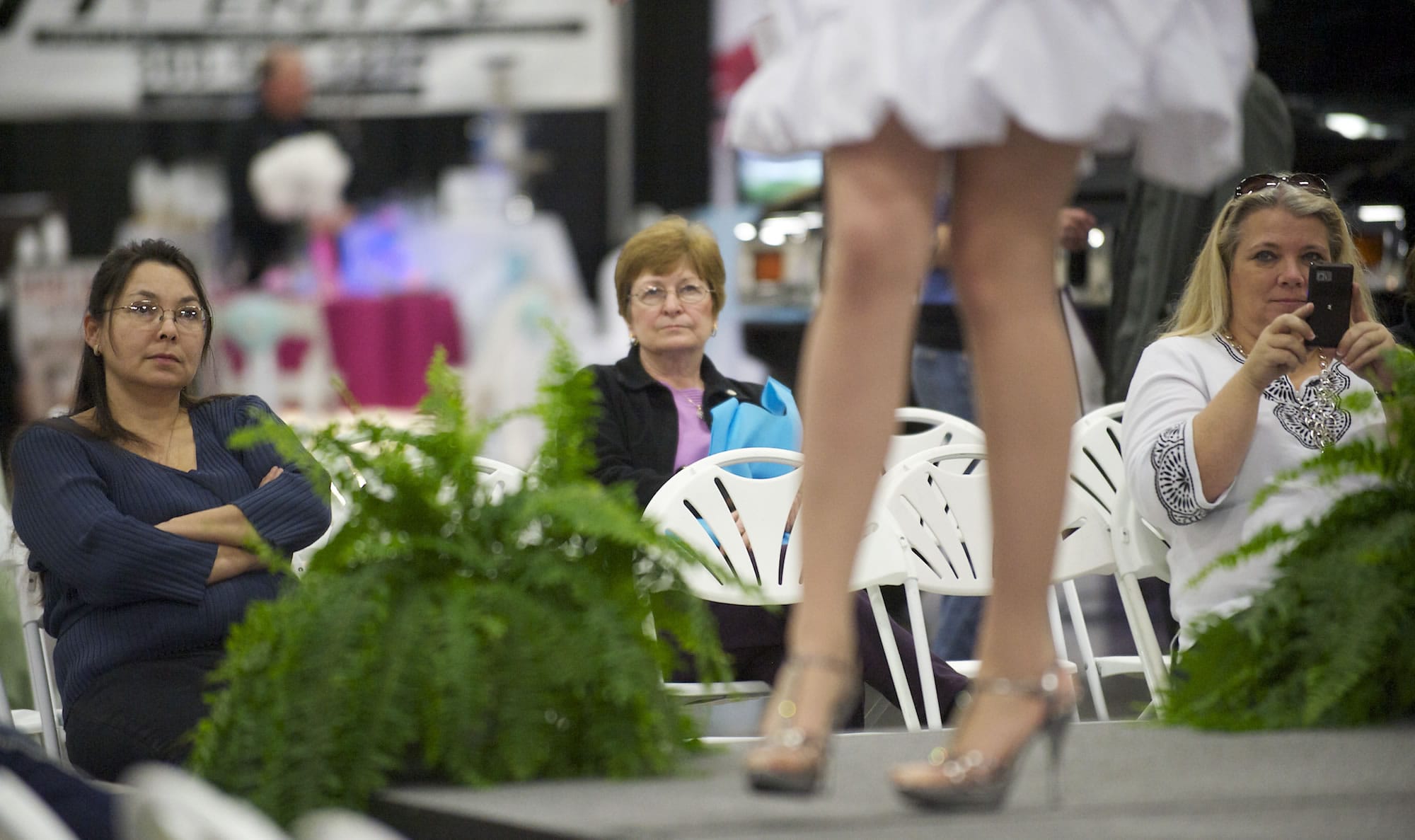 Evelyn Taul, left, of Vancouver watches for ideas as she helps her sister, Anna Douglas, not pictured, plan Anna's wedding, set for Aug.