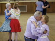 Elmer Toops kisses his wife, Betty, at the Hazel Dell Grange Hall recently.