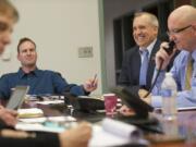 Clark County Commissioners Steve Stuart, from left, David Madore and Clark County Administrator Bill Barron, along with staff members and members of the public, meet at the Clark County Public Service Center on Wednesday.