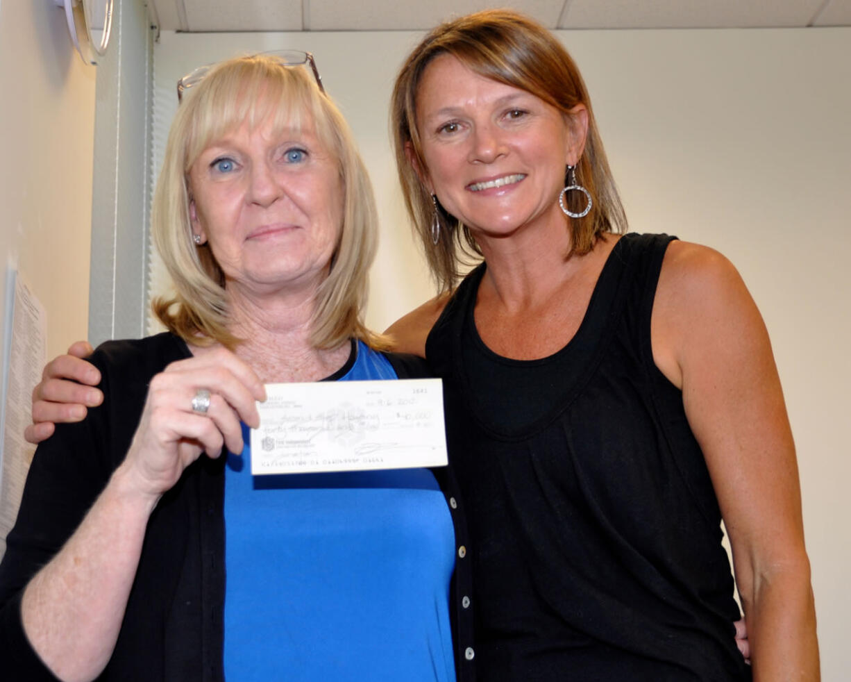 Ridgefield: Debby Dover, left, of Second Step Housing gets a gift from Tina Eifert of Cameo.