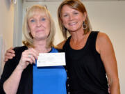 Ridgefield: Debby Dover, left, of Second Step Housing gets a gift from Tina Eifert of Cameo.